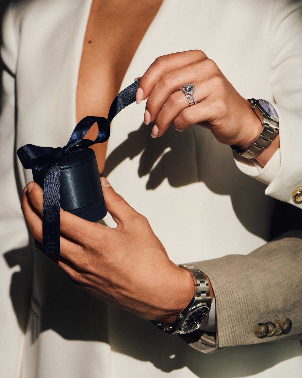 A client receives a Création Paul H box tied with a ribbon