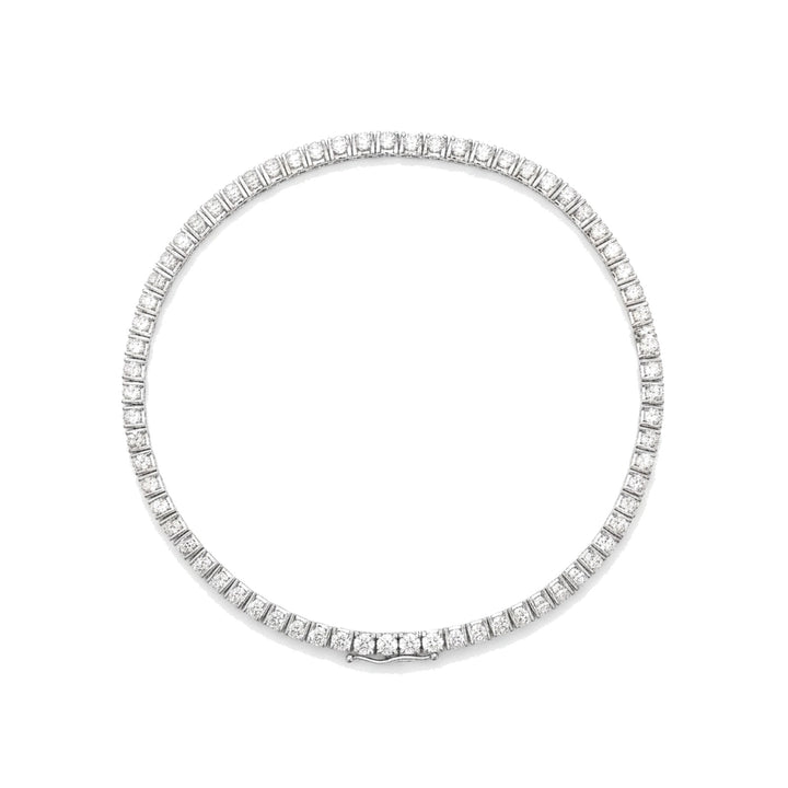 Diamond tennis bracelet in white gold, top view, lying flat. Creation Paul H