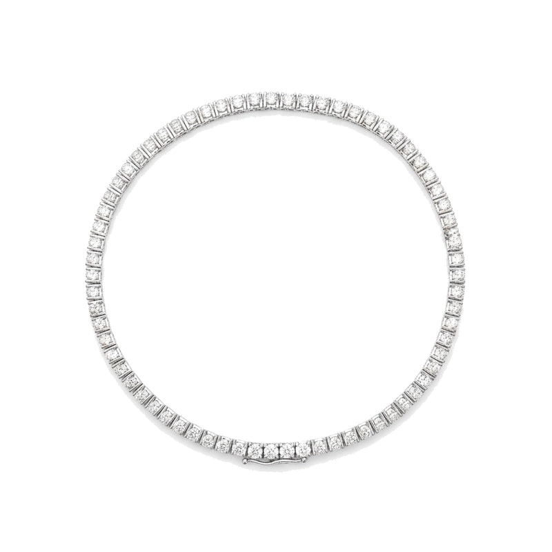 Diamond tennis bracelet in white gold, top view, lying flat. Creation Paul H