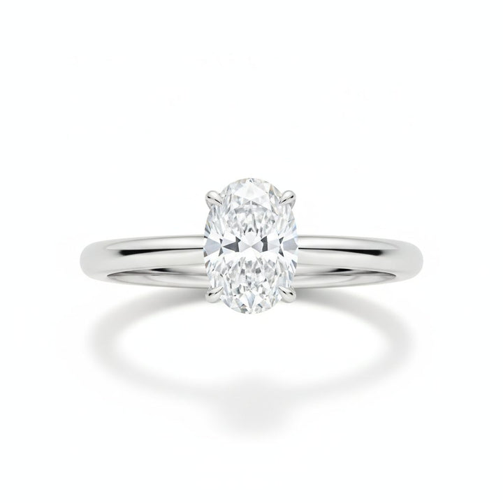 Oval solitaire engagement ring in white gold, lab-grown diamond, front view. Creation Paul H